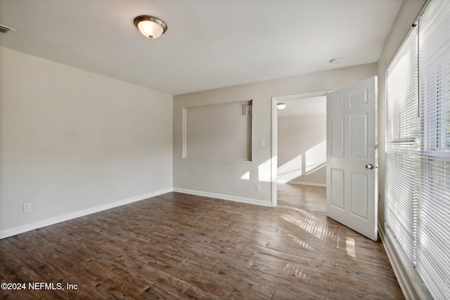 spare room with hardwood / wood-style floors