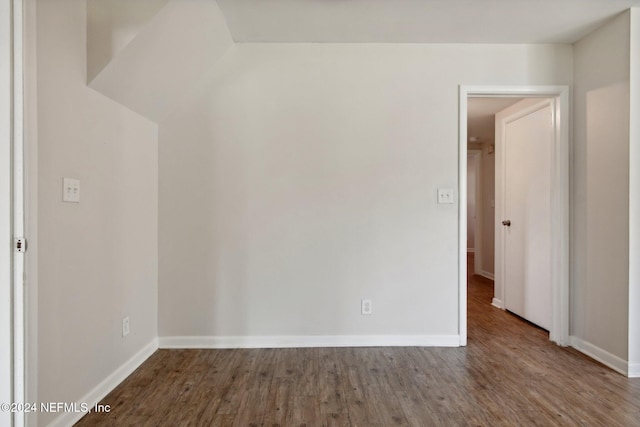 spare room with dark hardwood / wood-style floors