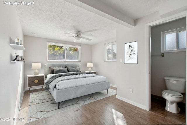 bedroom with a textured ceiling, light hardwood / wood-style flooring, and ceiling fan