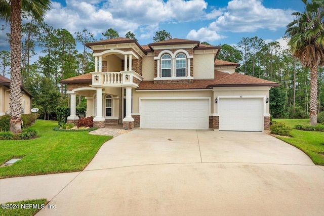 mediterranean / spanish home featuring a front lawn and a garage