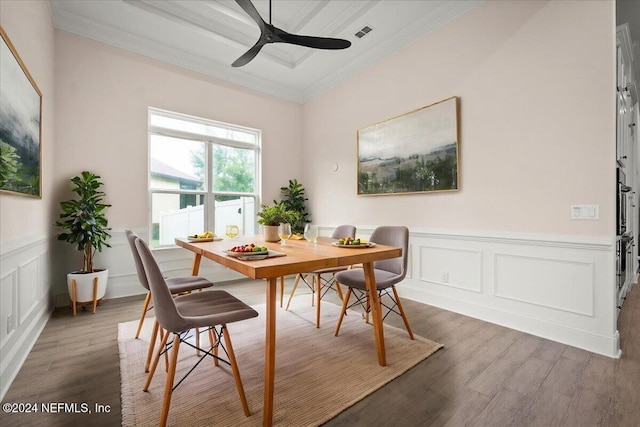 dining room featuring ornamental molding, dark wood-type flooring, and ceiling fan