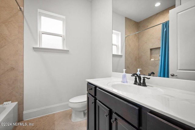 full bathroom featuring vanity, shower / bath combo with shower curtain, toilet, and tile patterned floors