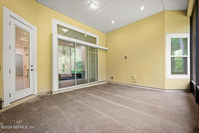 empty room with carpet, vaulted ceiling, and wooden ceiling