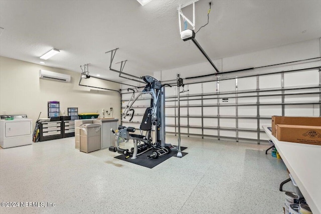 exercise room featuring a wall unit AC, a textured ceiling, and washer / clothes dryer