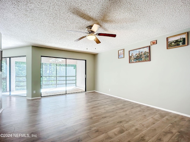 spare room featuring a textured ceiling, hardwood / wood-style flooring, and ceiling fan