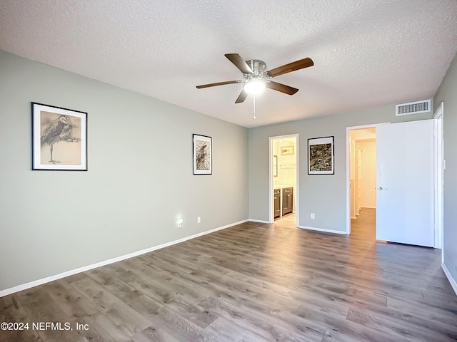 unfurnished room featuring hardwood / wood-style floors, a textured ceiling, and ceiling fan