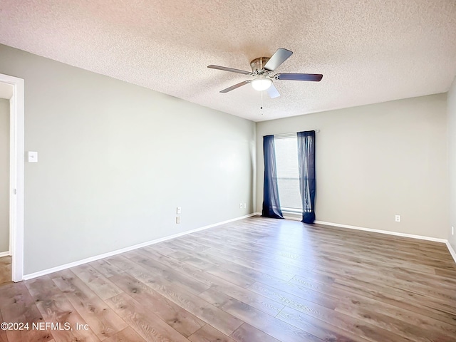 unfurnished room with ceiling fan, a textured ceiling, and hardwood / wood-style floors