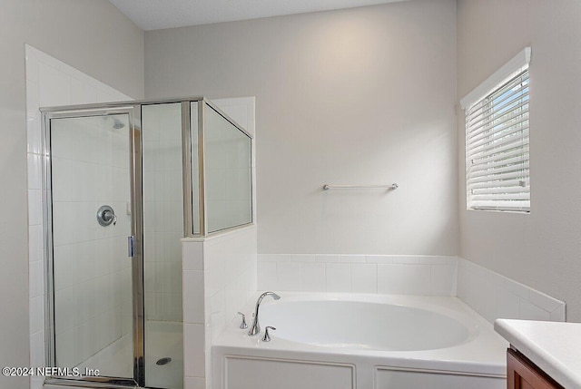 bathroom featuring vanity and separate shower and tub