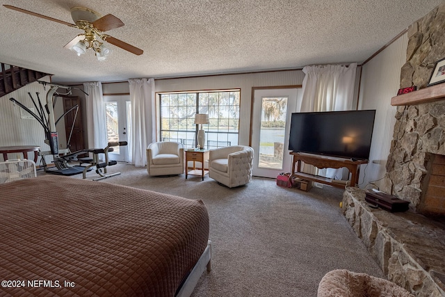 bedroom featuring a textured ceiling, carpet flooring, and ceiling fan