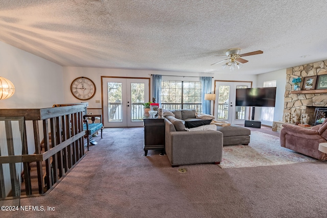 carpeted living room featuring french doors, a textured ceiling, and ceiling fan