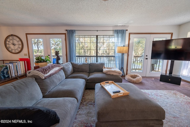 living room with french doors, carpet, and a textured ceiling