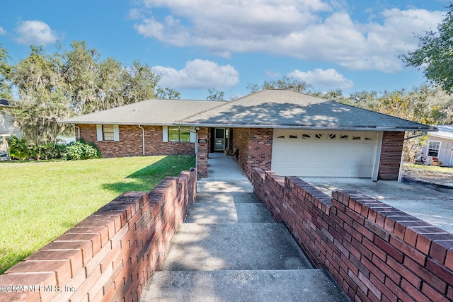 ranch-style house featuring a garage and a front lawn