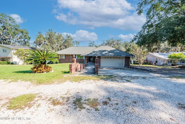 single story home with a front yard and a garage