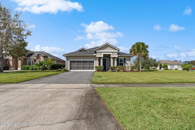 view of front of property featuring a front yard and a garage