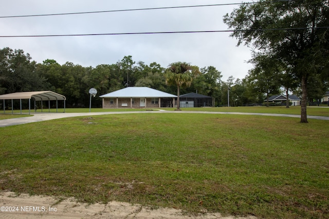 farmhouse inspired home featuring a front lawn and a carport