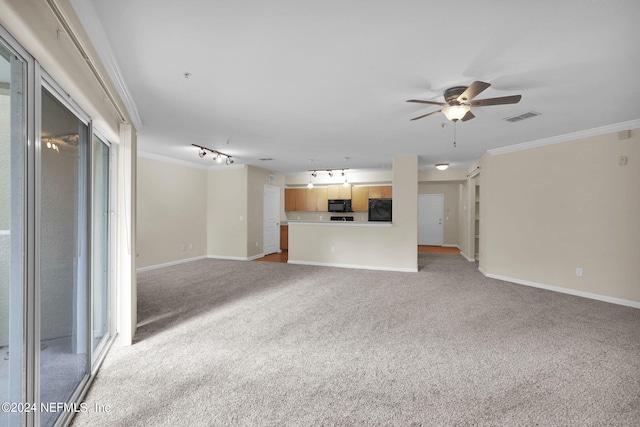 unfurnished living room featuring crown molding, light colored carpet, track lighting, and ceiling fan