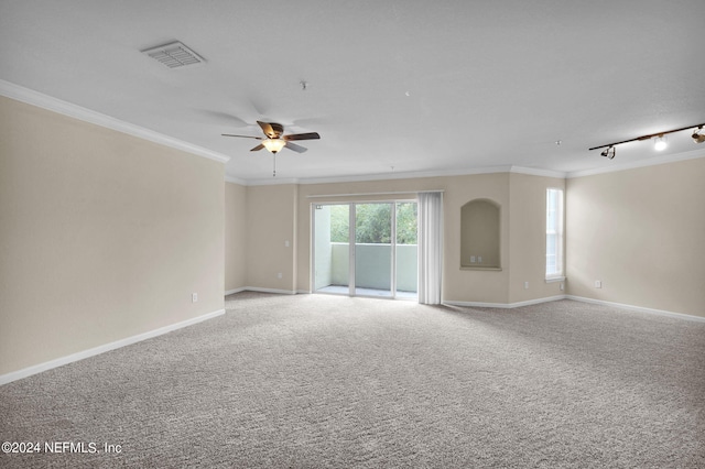 spare room featuring ornamental molding, track lighting, carpet floors, and ceiling fan