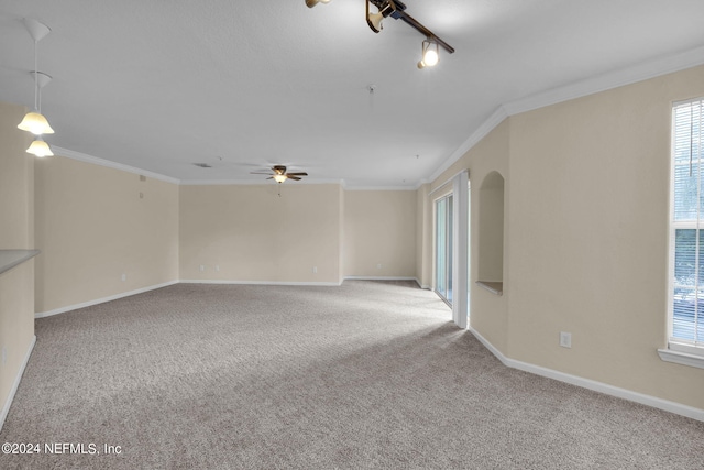 unfurnished room featuring light carpet, crown molding, a wealth of natural light, and ceiling fan