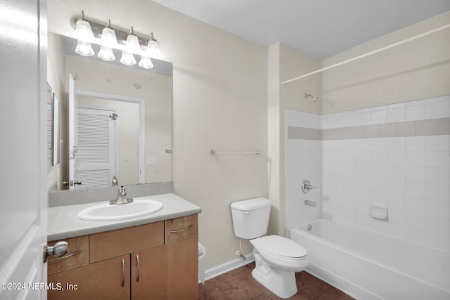 full bathroom featuring tiled shower / bath, vanity, toilet, and tile patterned floors