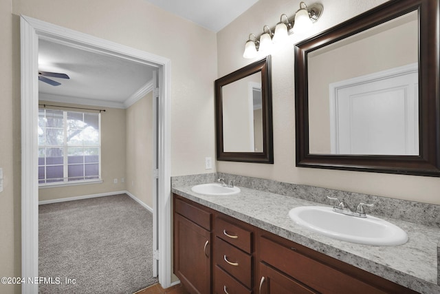 bathroom featuring vanity, crown molding, and ceiling fan