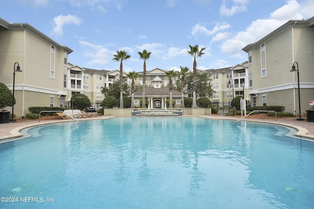 view of swimming pool with a gazebo, central air condition unit, and a patio