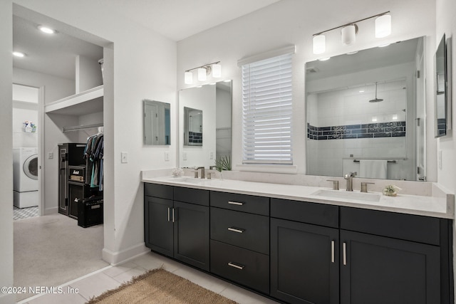 bathroom featuring vanity, tile patterned floors, washer / dryer, and tiled shower