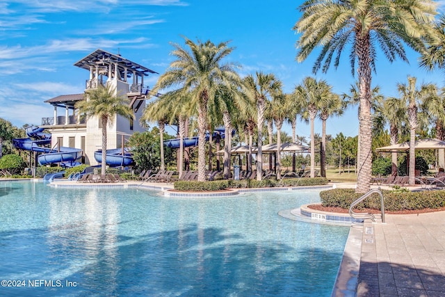 view of swimming pool with a water slide