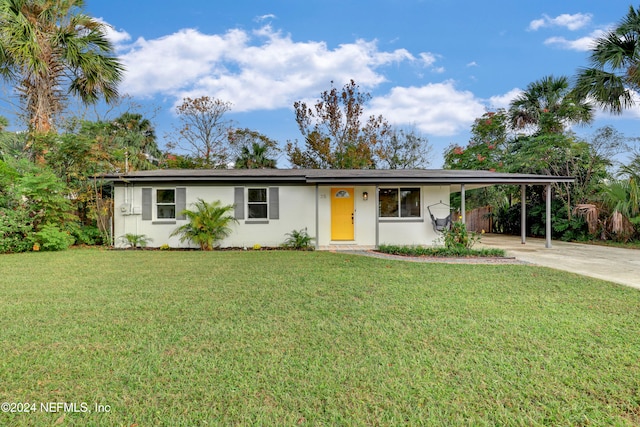 single story home with a front yard and a carport