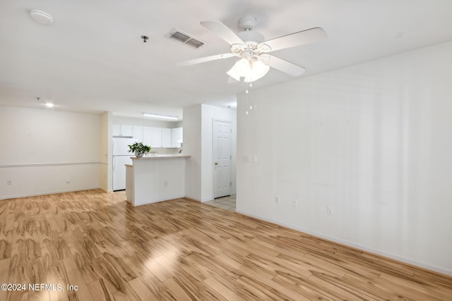 empty room featuring ceiling fan and light hardwood / wood-style floors