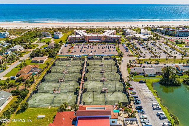 drone / aerial view featuring a water view and a view of the beach