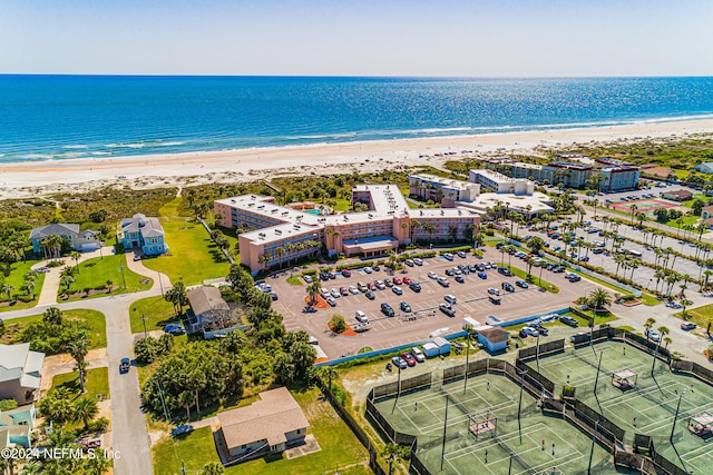 bird's eye view with a water view and a beach view