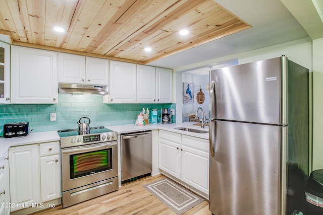 4 Ocean Trace Rd Unit 102, Saint Augustine, FL 32080 - kitchen with a sink, wood ceiling, appliances with stainless steel finishes, light countertops, and under cabinet range hood