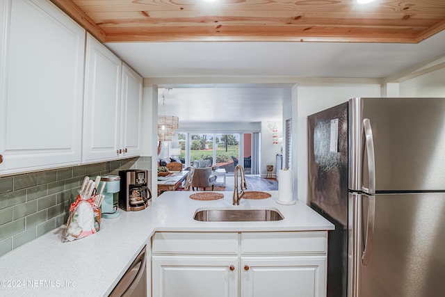 4 Ocean Trace Rd Unit 102, Saint Augustine, FL 32080 - kitchen featuring wood ceiling, stainless steel appliances, a sink, and white cabinetry