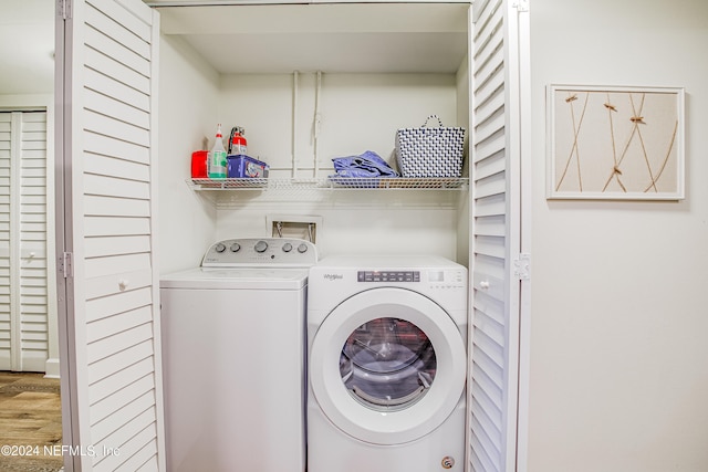 laundry area featuring washer and dryer and wood-type flooring