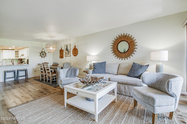 living room with a notable chandelier and hardwood / wood-style floors