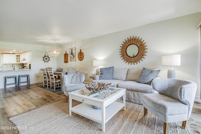 4 Ocean Trace Rd Unit 102, Saint Augustine, FL 32080 - living area with baseboards, wood finished floors, and a notable chandelier