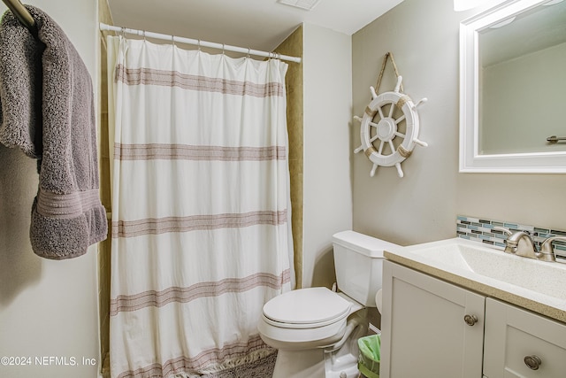 4 Ocean Trace Rd Unit 102, Saint Augustine, FL 32080 - bathroom with decorative backsplash, vanity, curtained shower, toilet, and visible vents