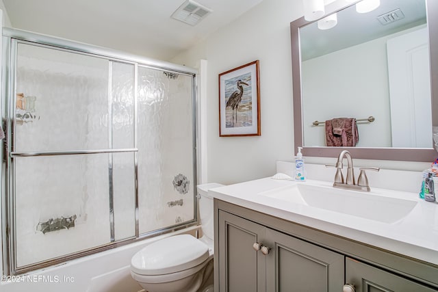 4 Ocean Trace Rd Unit 102, Saint Augustine, FL 32080 - full bath with shower / bath combination with glass door, toilet, vanity, and visible vents