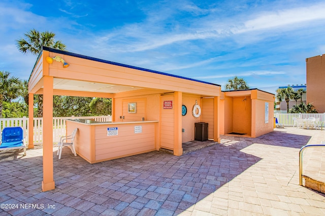 4 Ocean Trace Rd Unit 102, Saint Augustine, FL 32080 - view of patio / terrace with outdoor dry bar and fence