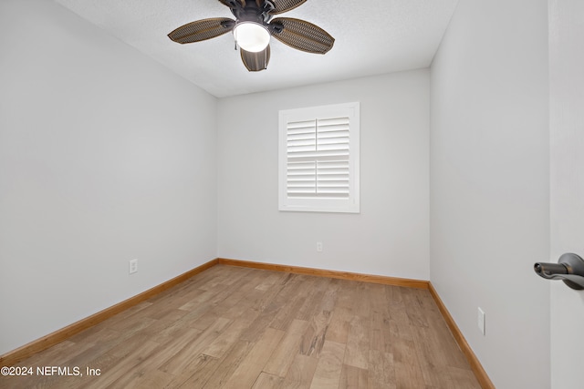 spare room featuring ceiling fan, a textured ceiling, and light wood-type flooring