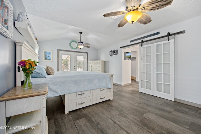 bedroom featuring lofted ceiling, french doors, dark hardwood / wood-style floors, a barn door, and ceiling fan