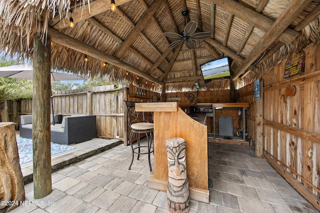 view of patio with a gazebo, ceiling fan, and an outdoor bar