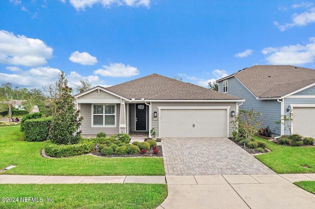 view of front facade featuring a front yard and a garage