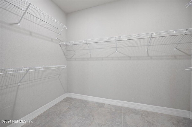 spacious closet featuring tile patterned floors