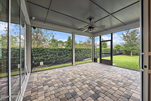 unfurnished sunroom featuring ceiling fan