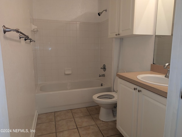 full bathroom featuring vanity, tiled shower / bath combo, toilet, and tile patterned flooring