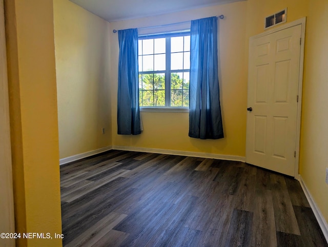 spare room with dark hardwood / wood-style floors