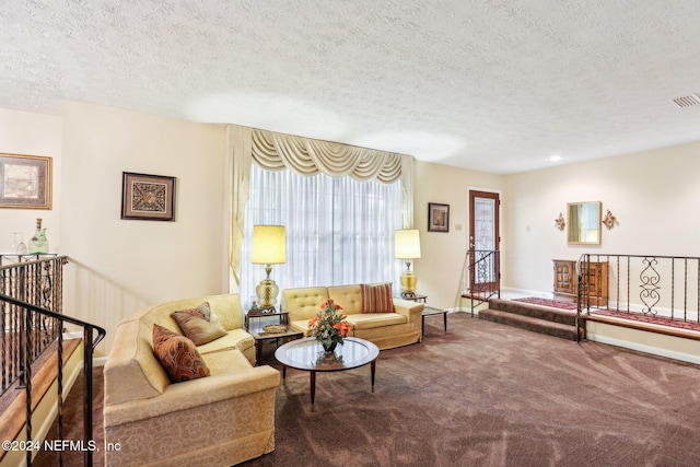 carpeted living room featuring a textured ceiling