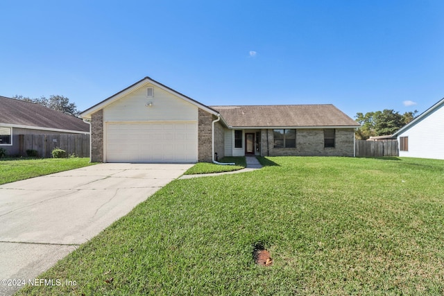 ranch-style home with a front yard and a garage