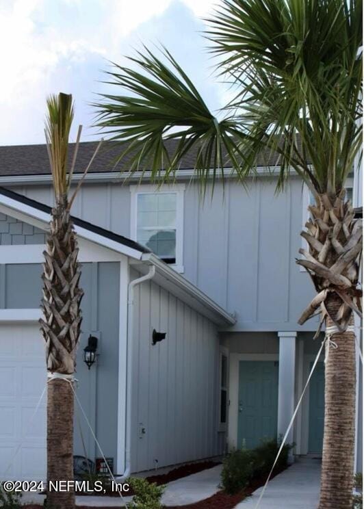 exterior space with board and batten siding and an attached garage